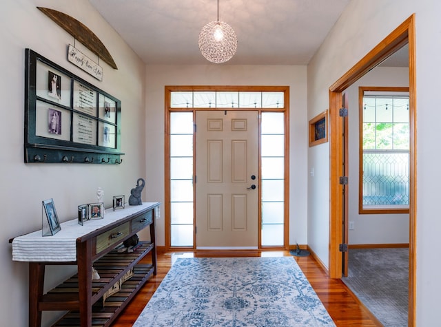 entryway featuring wood finished floors and baseboards