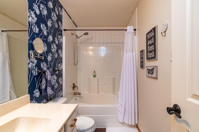 full bath with a textured ceiling, toilet, vanity, and shower / bath combo with shower curtain