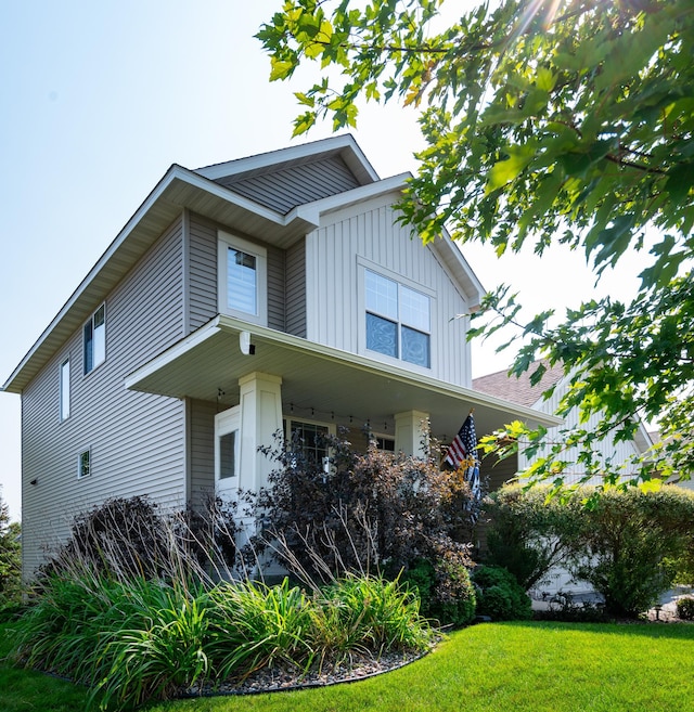 view of front of home with board and batten siding and a front lawn