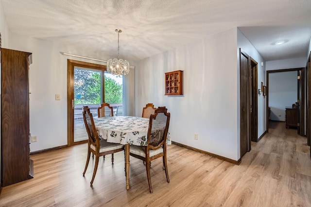 792 Gramsie Rd, Shoreview, MN 55126 - dining area featuring a chandelier, baseboards, and light wood-type flooring