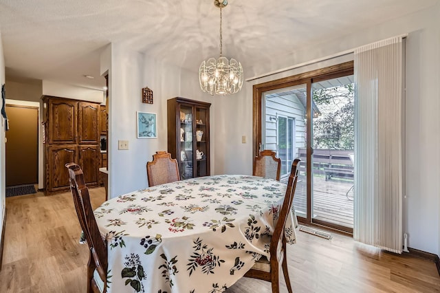792 Gramsie Rd, Shoreview, MN 55126 - dining room with light wood-style flooring and a chandelier
