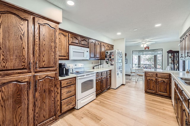792 Gramsie Rd, Shoreview, MN 55126 - kitchen with white appliances, light wood finished floors, recessed lighting, a ceiling fan, and light countertops