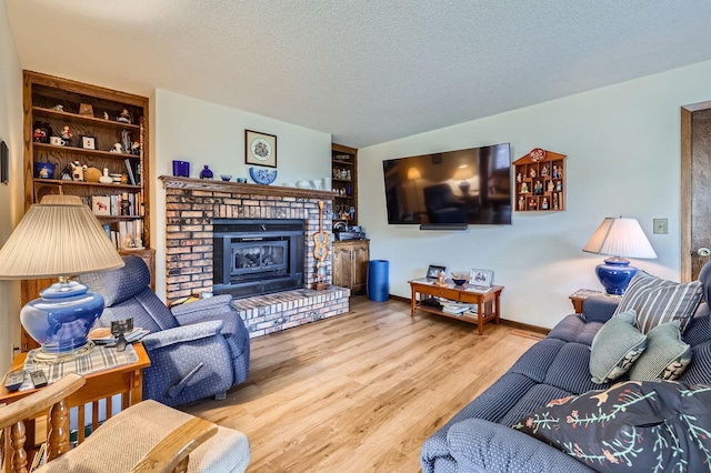 792 Gramsie Rd, Shoreview, MN 55126 - living area with wood finished floors, a textured ceiling, and a fireplace