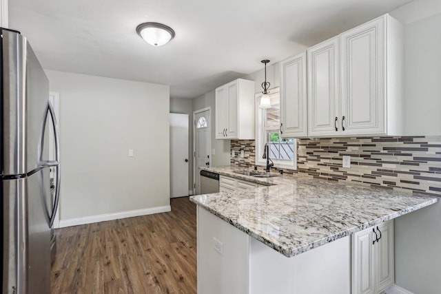 2016 90th St, Bloomington, MN 55431 - kitchen featuring stainless steel appliances, a sink, baseboards, dark wood-style floors, and tasteful backsplash