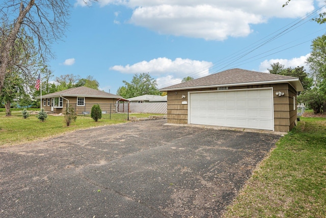 2016 90th St, Bloomington, MN 55431 - view of home's exterior featuring a garage, an outbuilding, and roof with shingles