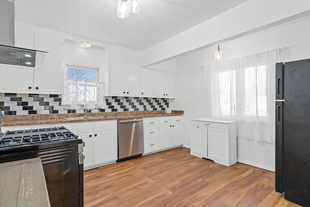kitchen featuring a sink, decorative backsplash, black appliances, white cabinets, and light wood-type flooring
