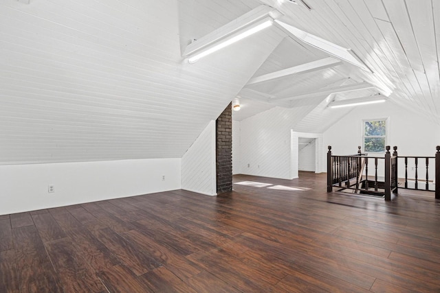 additional living space with lofted ceiling with beams and wood finished floors