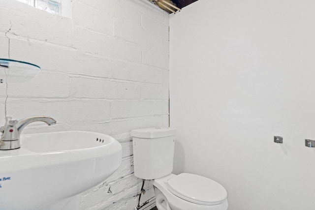 half bathroom featuring toilet and a sink