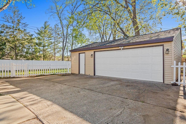 detached garage featuring fence