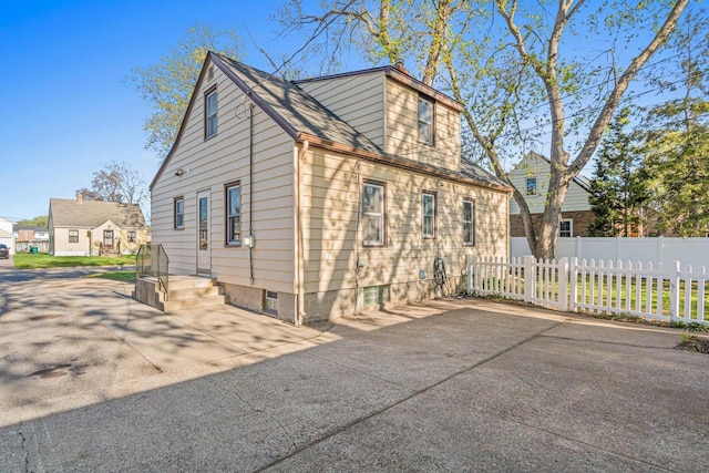 view of side of home with fence