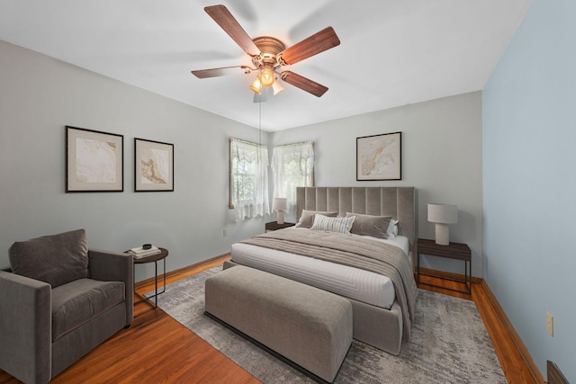 600 Mclean St, Mora, MN 55051 - bedroom with wood finished floors, baseboards, and ceiling fan