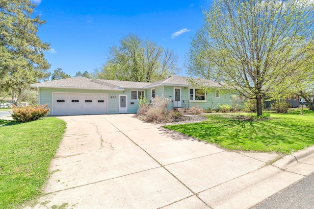 600 Mclean St, Mora, MN 55051 - ranch-style house with an attached garage, concrete driveway, and a front yard
