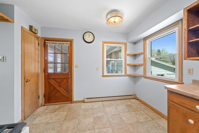 600 Mclean St, Mora, MN 55051 - doorway to outside featuring a baseboard heating unit and baseboards