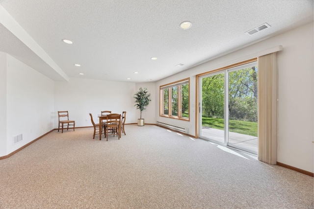 10715 57th Ave N, Plymouth, MN 55442 - dining area featuring baseboard heating, light carpet, recessed lighting, baseboards, and a textured ceiling