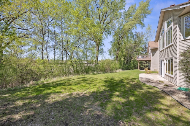 10715 57th Ave N, Plymouth, MN 55442 - view of green lawn with a patio area and a wooden deck
