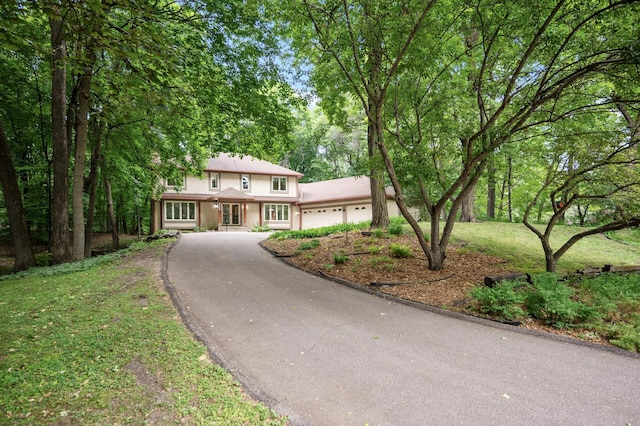 18021 Priory Ln, Minnetonka, MN 55345 - view of front of house with a garage, driveway, and stucco siding