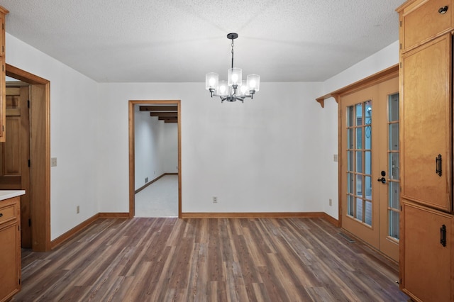 18021 Priory Ln, Minnetonka, MN 55345 - unfurnished dining area with french doors, dark wood-style floors, a chandelier, and a textured ceiling