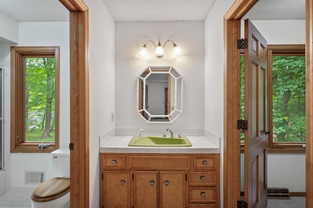 18021 Priory Ln, Minnetonka, MN 55345 - bathroom featuring vanity and a textured ceiling