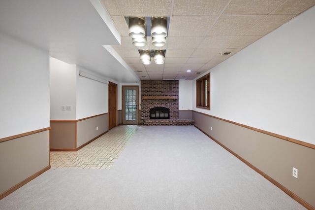 18021 Priory Ln, Minnetonka, MN 55345 - below grade area featuring a fireplace, brick patterned floors, a drop ceiling, and carpet floors