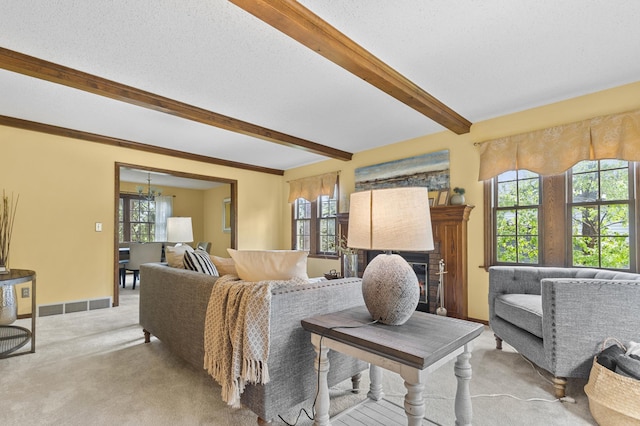 1228 Tamberwood Trl, Woodbury, MN 55125 - living area with light carpet, beamed ceiling, plenty of natural light, a chandelier, and a fireplace