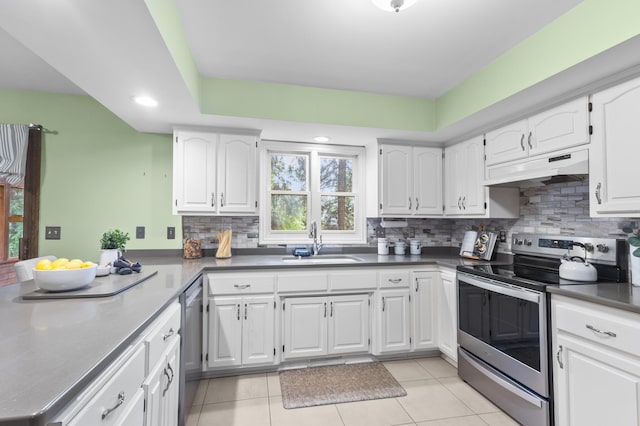 1228 Tamberwood Trl, Woodbury, MN 55125 - kitchen with appliances with stainless steel finishes, a sink, under cabinet range hood, backsplash, and white cabinets