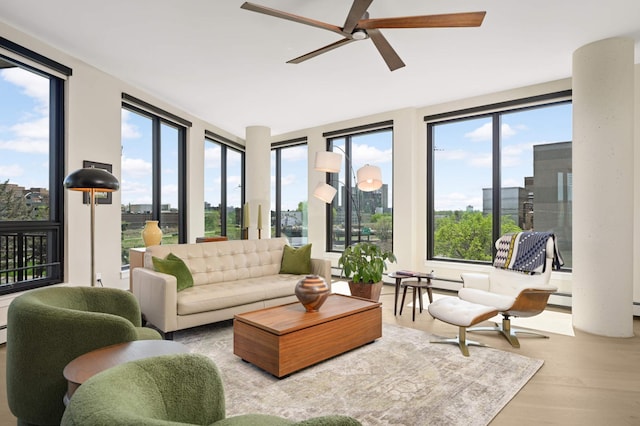 living room with wood finished floors, ceiling fan, and a baseboard heating unit