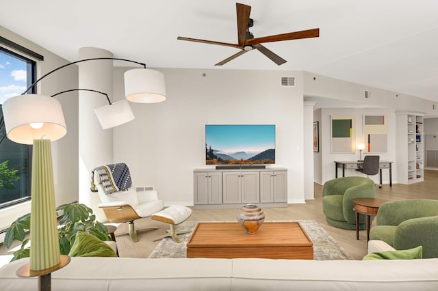living room with ceiling fan, light wood-style floors, and baseboards