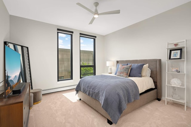 bedroom featuring a baseboard heating unit, light carpet, and ceiling fan