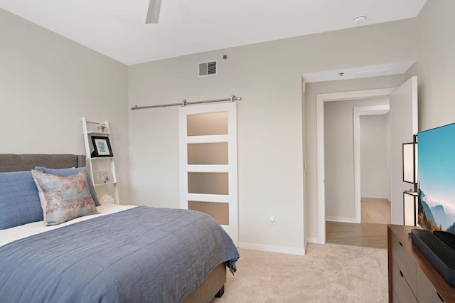 bedroom with light carpet, a ceiling fan, and baseboards