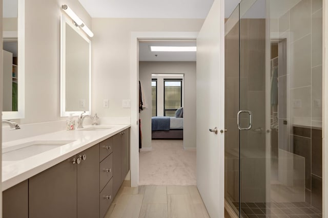 bathroom with a shower stall, double vanity, ensuite bath, and tile patterned flooring