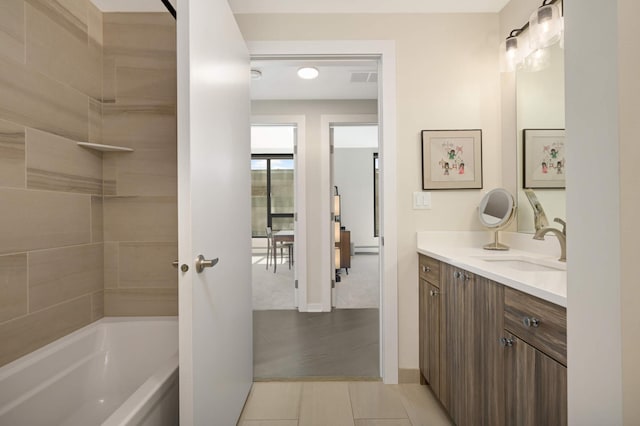 bathroom with vanity, baseboards, and tile patterned flooring