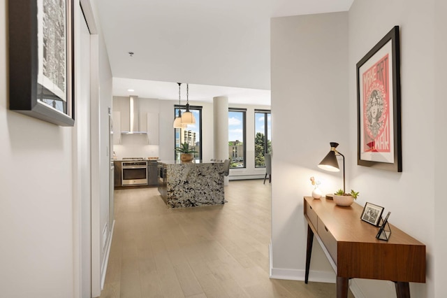 living room featuring light wood-style flooring, baseboards, and recessed lighting