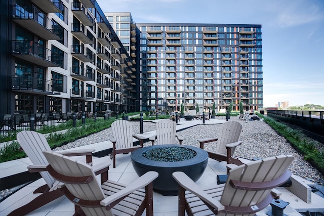 view of patio featuring a fire pit and fence