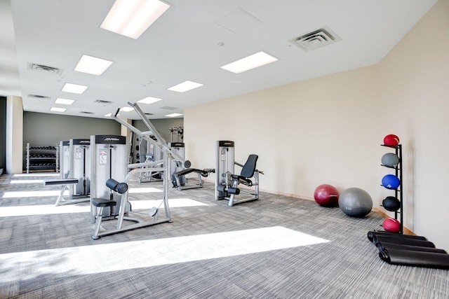 exercise room with carpet floors and baseboards