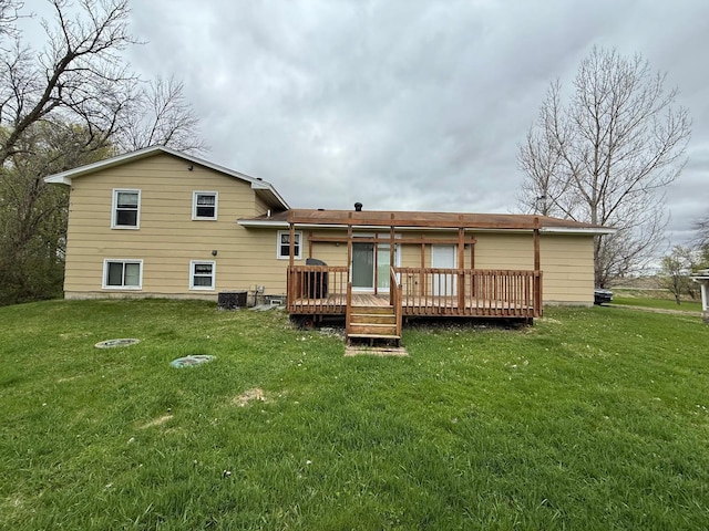 rear view of house with a yard, a deck, and cooling unit