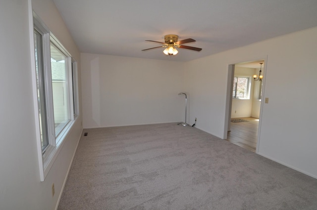 811 Pleasant Ave S, Park Rapids, MN 56470 - unfurnished room with light colored carpet, ceiling fan with notable chandelier, and baseboards