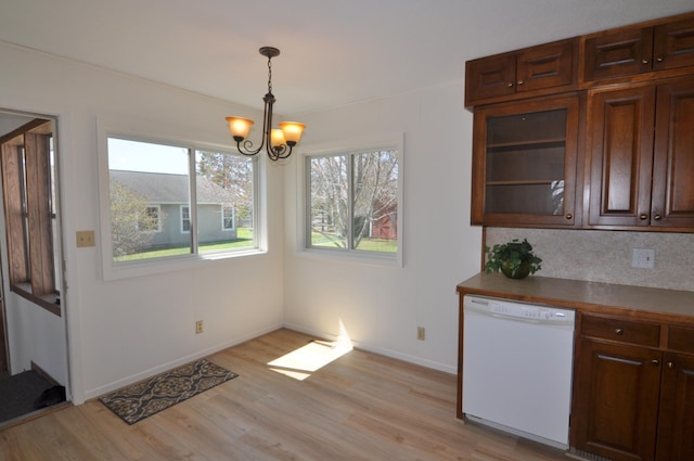 811 Pleasant Ave S, Park Rapids, MN 56470 - unfurnished dining area with light wood finished floors, a chandelier, and baseboards