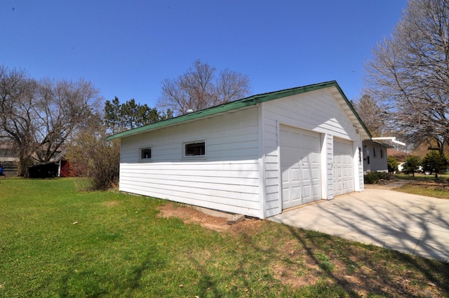 811 Pleasant Ave S, Park Rapids, MN 56470 - exterior space featuring a detached garage, an outbuilding, and a lawn