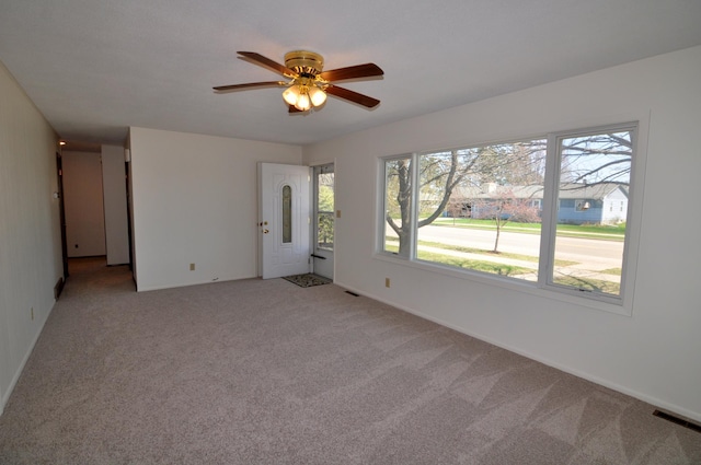 811 Pleasant Ave S, Park Rapids, MN 56470 - empty room with a healthy amount of sunlight, ceiling fan, light carpet, and visible vents