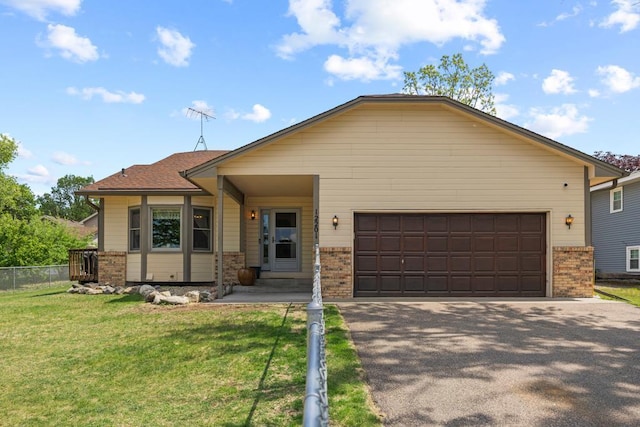12201 Olive St NW, Coon Rapids, MN 55448 - view of front facade with brick siding, an attached garage, and asphalt driveway