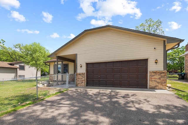 12201 Olive St NW, Coon Rapids, MN 55448 - view of front of property with brick siding, a garage, and driveway