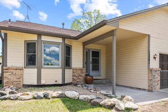 12201 Olive St NW, Coon Rapids, MN 55448 - entrance to property featuring brick siding, fence, and a gate