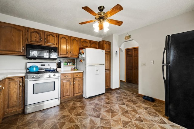 12201 Olive St NW, Coon Rapids, MN 55448 - kitchen featuring black appliances, ceiling fan, light countertops, and brown cabinetry