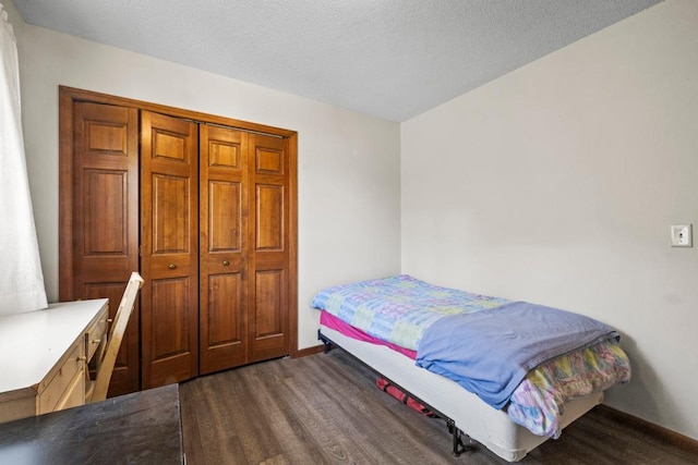 12201 Olive St NW, Coon Rapids, MN 55448 - bedroom featuring dark wood finished floors and baseboards