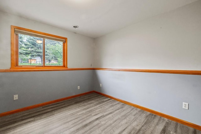 12201 Olive St NW, Coon Rapids, MN 55448 - unfurnished room featuring wood finished floors and baseboards