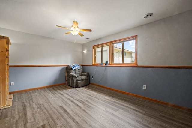 12201 Olive St NW, Coon Rapids, MN 55448 - unfurnished room featuring a ceiling fan, wood finished floors, and baseboards