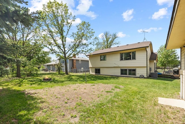 12201 Olive St NW, Coon Rapids, MN 55448 - back of house featuring a fire pit and central air condition unit
