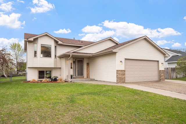 5046 Mitchell Rd, Big Lake, MN 55309 - split level home featuring driveway, a garage, a shingled roof, and brick siding