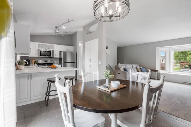 5046 Mitchell Rd, Big Lake, MN 55309 - dining area featuring lofted ceiling, a chandelier, and track lighting