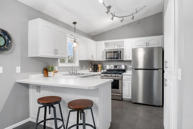5046 Mitchell Rd, Big Lake, MN 55309 - kitchen with appliances with stainless steel finishes, a sink, a peninsula, a breakfast bar area, and white cabinetry